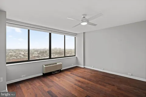 a bathroom with a granite countertop sink mirror and toilet