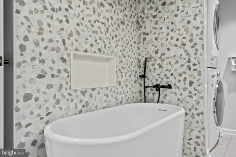 a bathroom with a granite countertop sink a toilet and a mirror