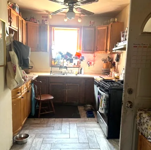 a kitchen with a sink stove and refrigerator