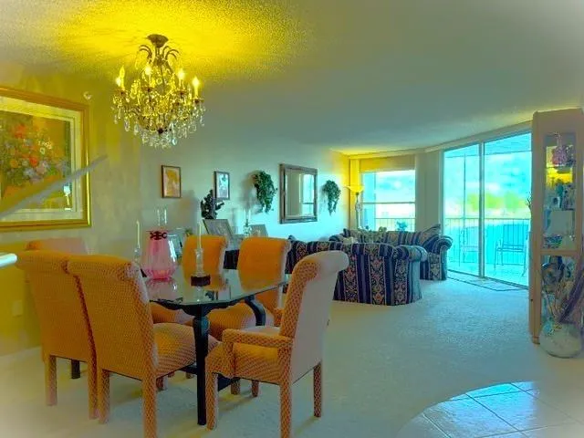 a view of a dining room with furniture and chandelier