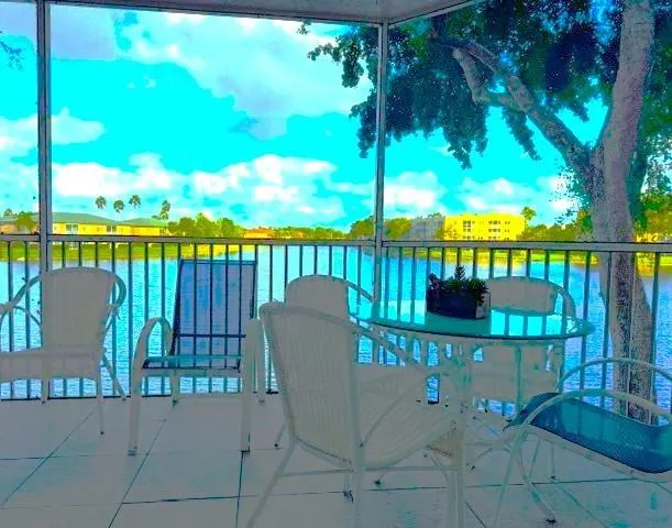 a view of a chair and table in the balcony