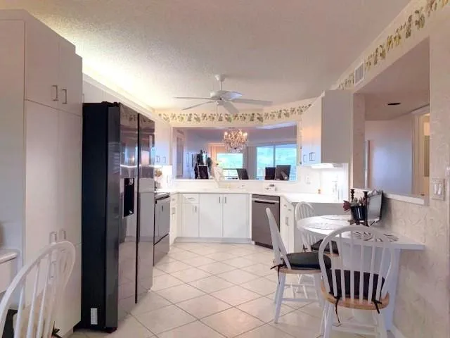 a kitchen with a refrigerator and a stove