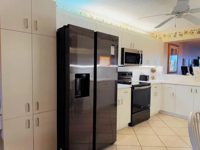a kitchen with stainless steel appliances a refrigerator stove and microwave