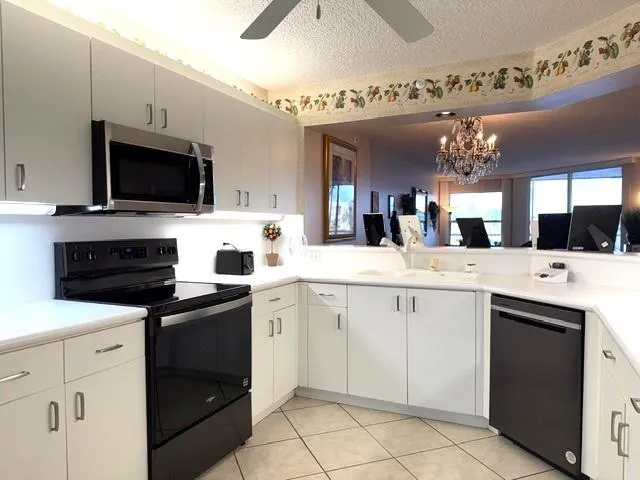 a kitchen with a sink and stove top oven