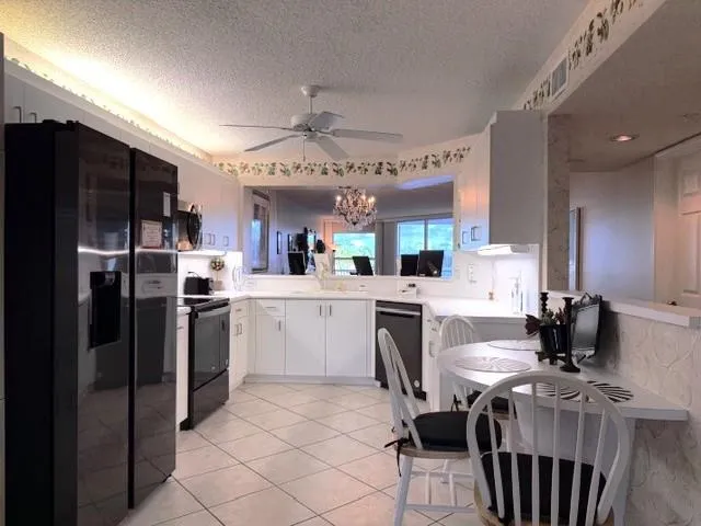 a kitchen with a refrigerator and a sink