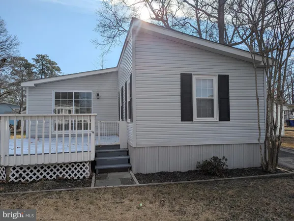 a view of a house with wooden fence
