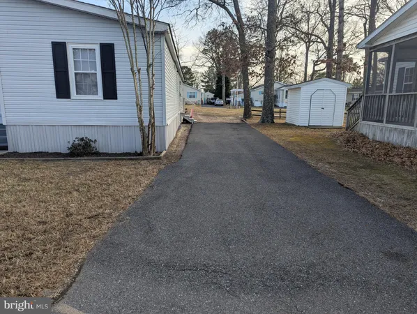 a view of a grey house with a yard