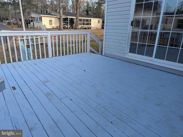 a view of a house with a wooden deck