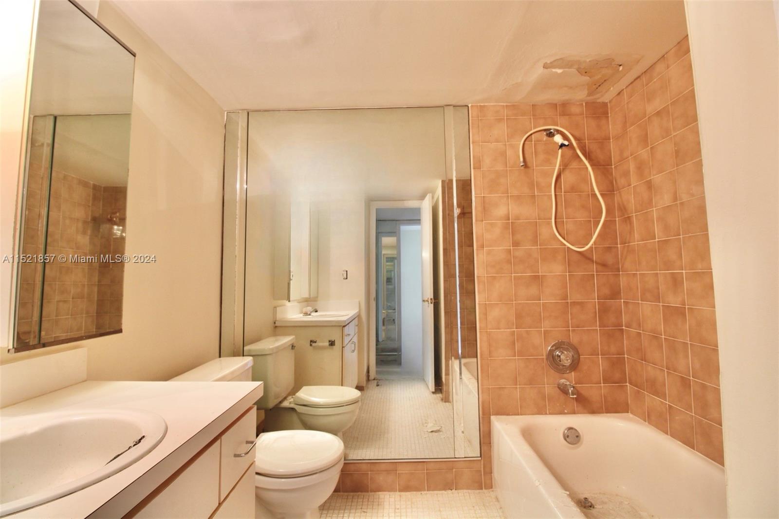 9015 Southwest 138th Street, Unit 162 Miami, FL 33176 - Photo 11 of 16 a bathroom with a sink a toilet and shower