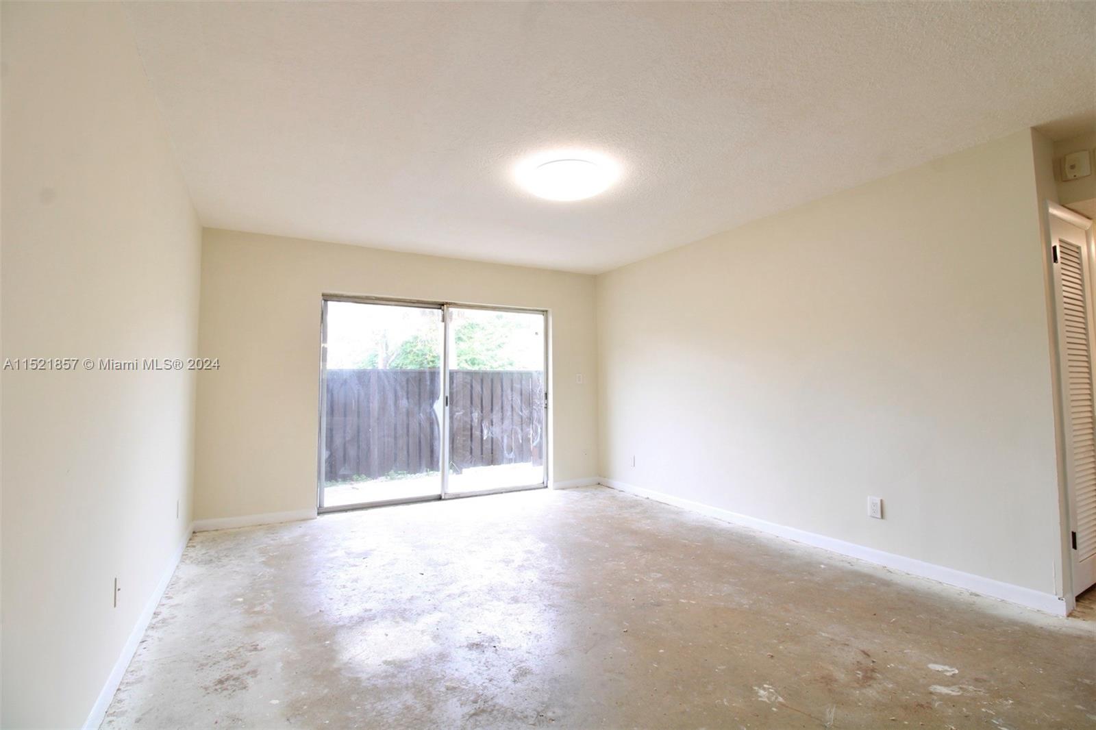 9015 Southwest 138th Street, Unit 162 Miami, FL 33176 - Photo 5 of 16 an empty room with a window
