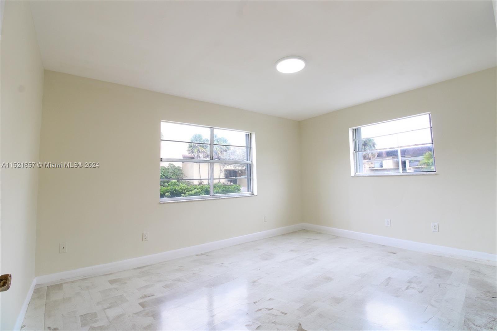 9015 Southwest 138th Street, Unit 162 Miami, FL 33176 - Photo 9 of 16 an empty room with windows