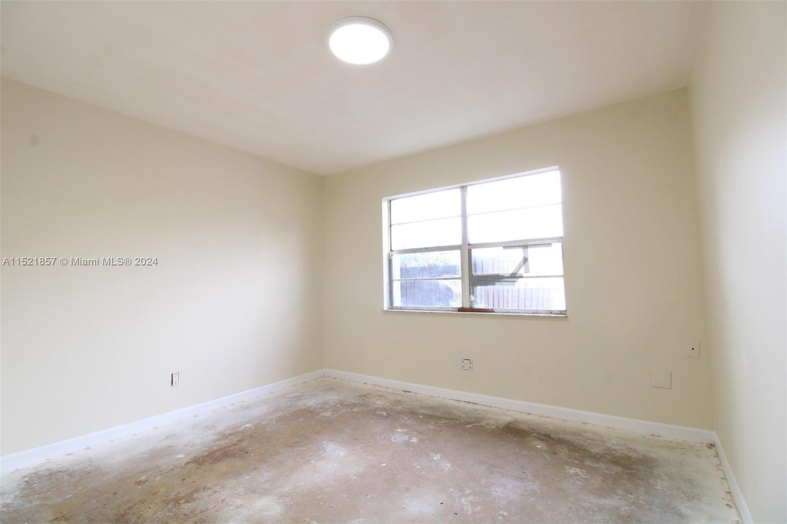 9015 Southwest 138th Street, Unit 162 Miami, FL 33176 - Photo 10 of 16 an empty room with a window