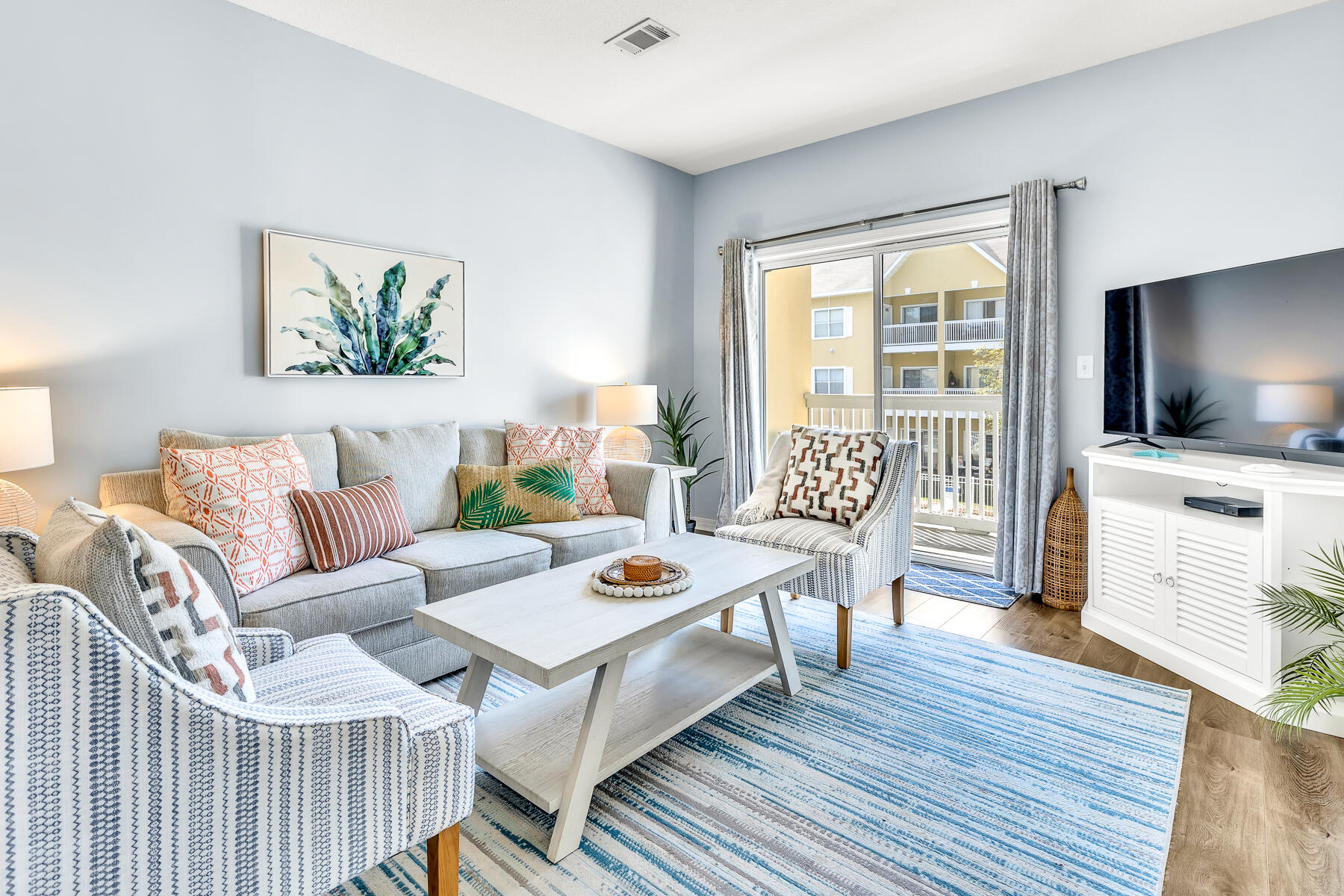 a living room with furniture and a flat screen tv
