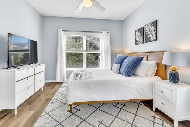 a bedroom with a bed and a flat screen tv
