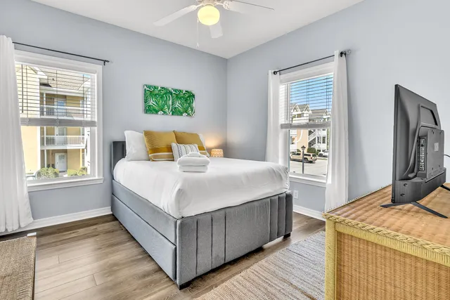 a bedroom with a bed and wooden floor