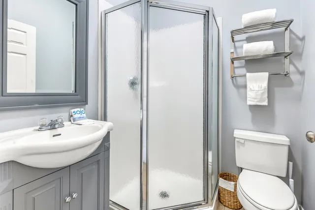 a bathroom with a toilet a sink and a mirror