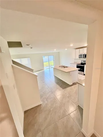 a kitchen with a sink a refrigerator and cabinets