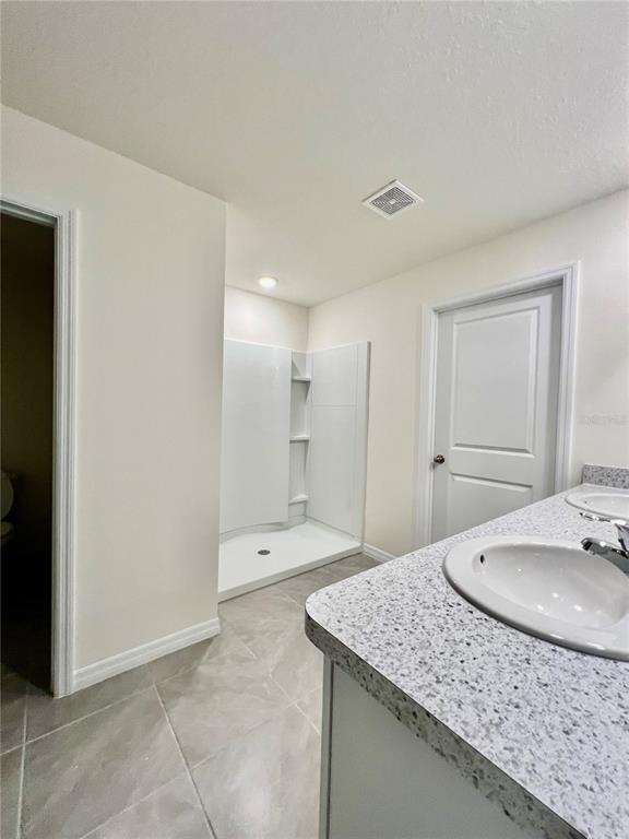 8884 Southwest 49th Circle Ocala, FL 34476 - Photo 25 of 39 a bathroom with a granite countertop sink and a mirror