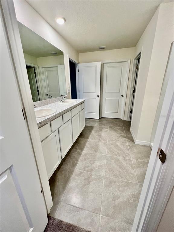8884 Southwest 49th Circle Ocala, FL 34476 - Photo 30 of 39 a bathroom with a sink a mirror and a vanity