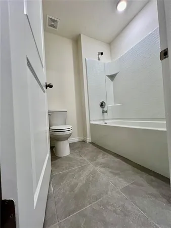 a kitchen with stainless steel appliances granite countertop a sink a stove and a refrigerator with wooden floor