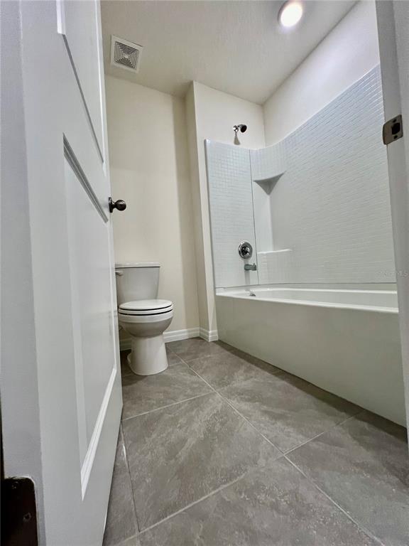 8884 Southwest 49th Circle Ocala, FL 34476 - Photo 34 of 39 a bathroom with a sink a toilet and a bathtub