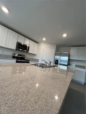 a kitchen with stainless steel appliances and a refrigerator