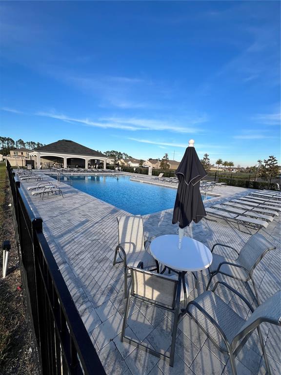 8884 Southwest 49th Circle Ocala, FL 34476 - Photo 5 of 39 a view of a chairs and table in patio