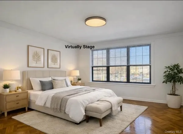 a bedroom with a large bed and wooden floor