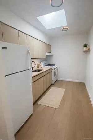 a kitchen with a sink and a refrigerator