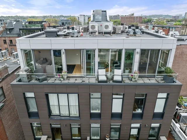a front view of a residential apartment building with a yard