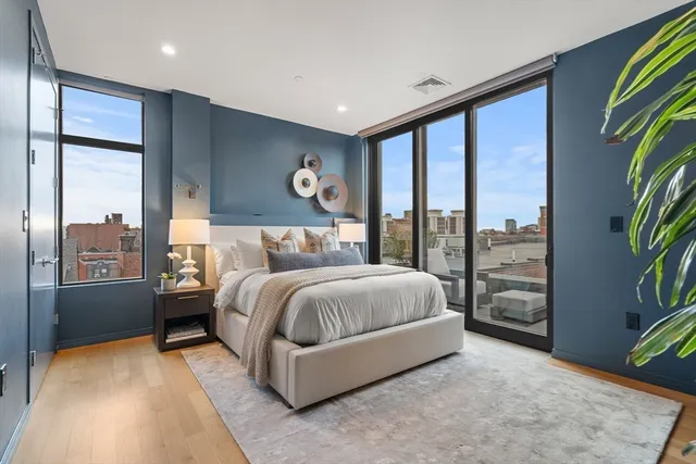 a bedroom with a large bed and a chandelier