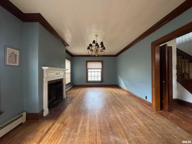 a view of an empty room window and wooden floor