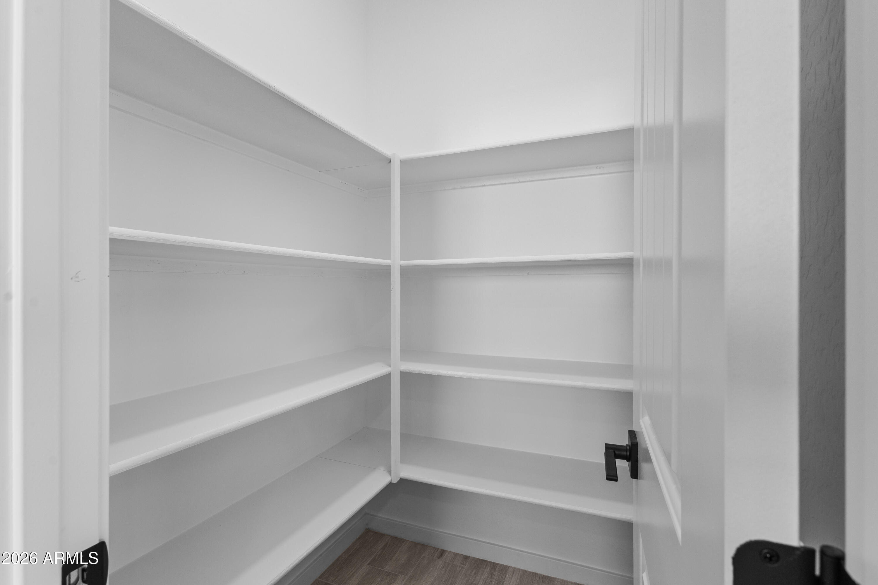 14045 South Berwick Road Arizona City, AZ 85123 - Photo 13 of 29 a view of walk in closet with empty racks