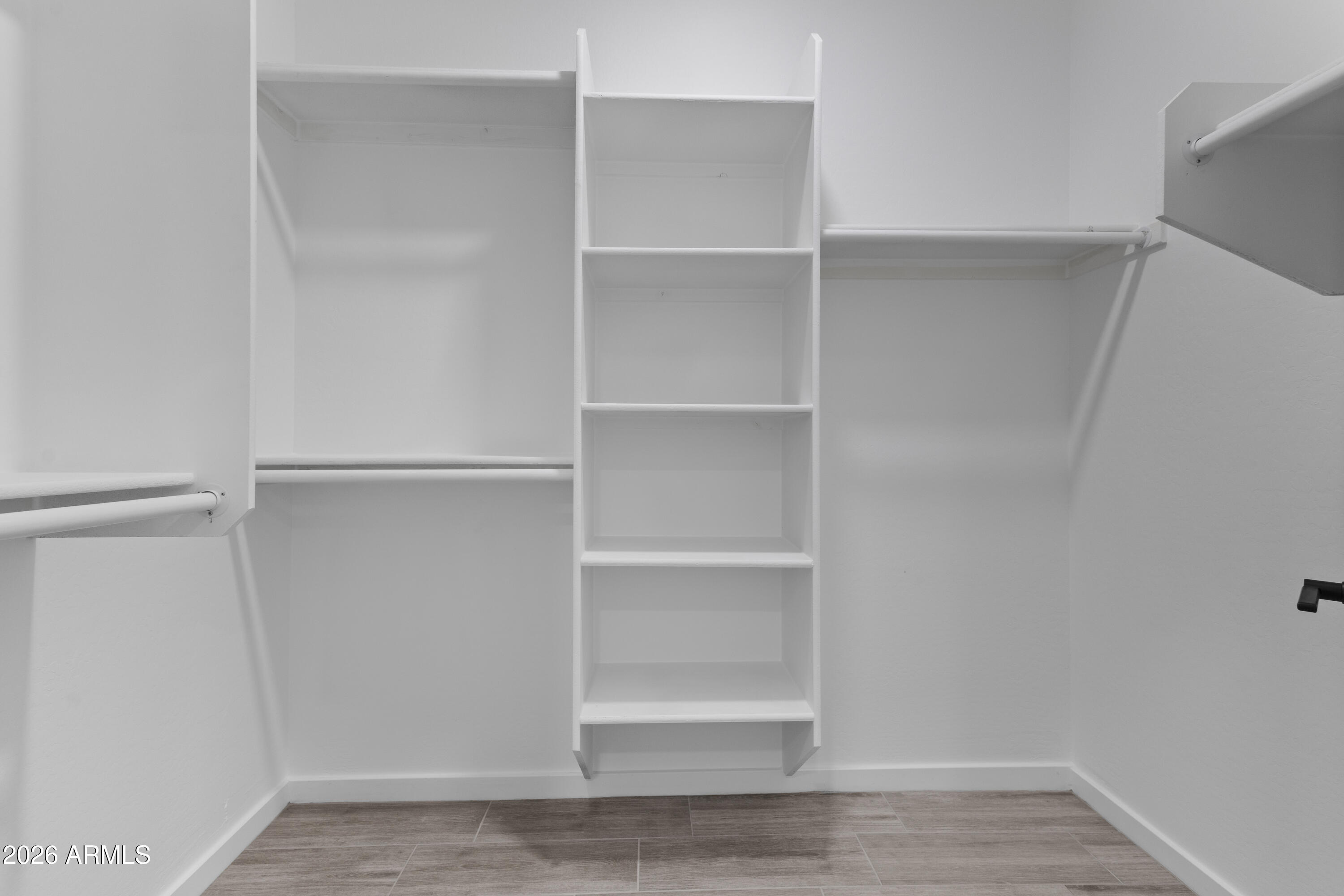 14045 South Berwick Road Arizona City, AZ 85123 - Photo 22 of 29 a view of walk in closet with empty racks