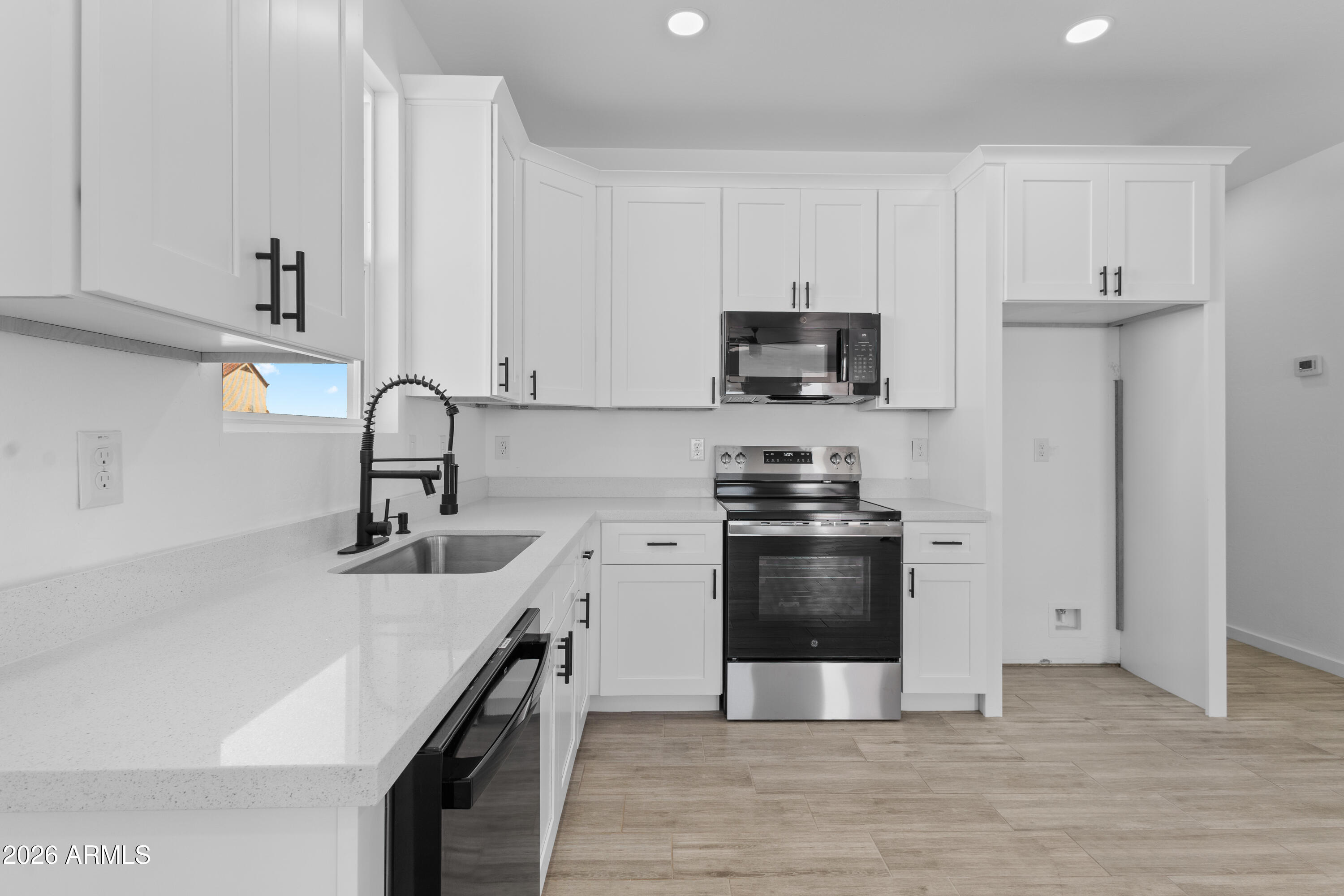 14045 South Berwick Road Arizona City, AZ 85123 - Photo 10 of 29 a kitchen with stainless steel appliances a sink stove and refrigerator