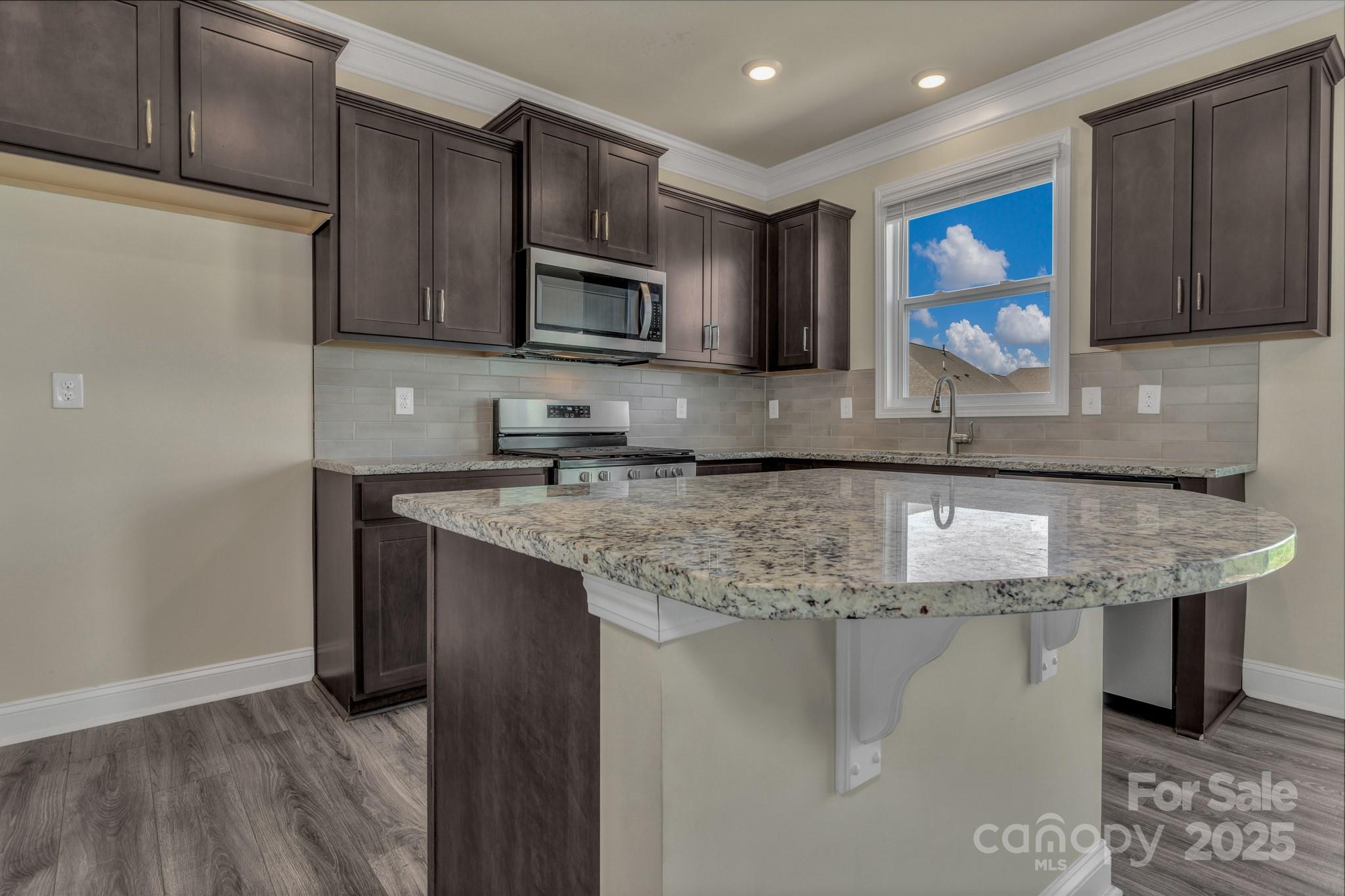 59 Thornberry Road Hendersonville, NC 28792 - Photo 16 of 48 a kitchen with stainless steel appliances granite countertop a sink a microwave and cabinets