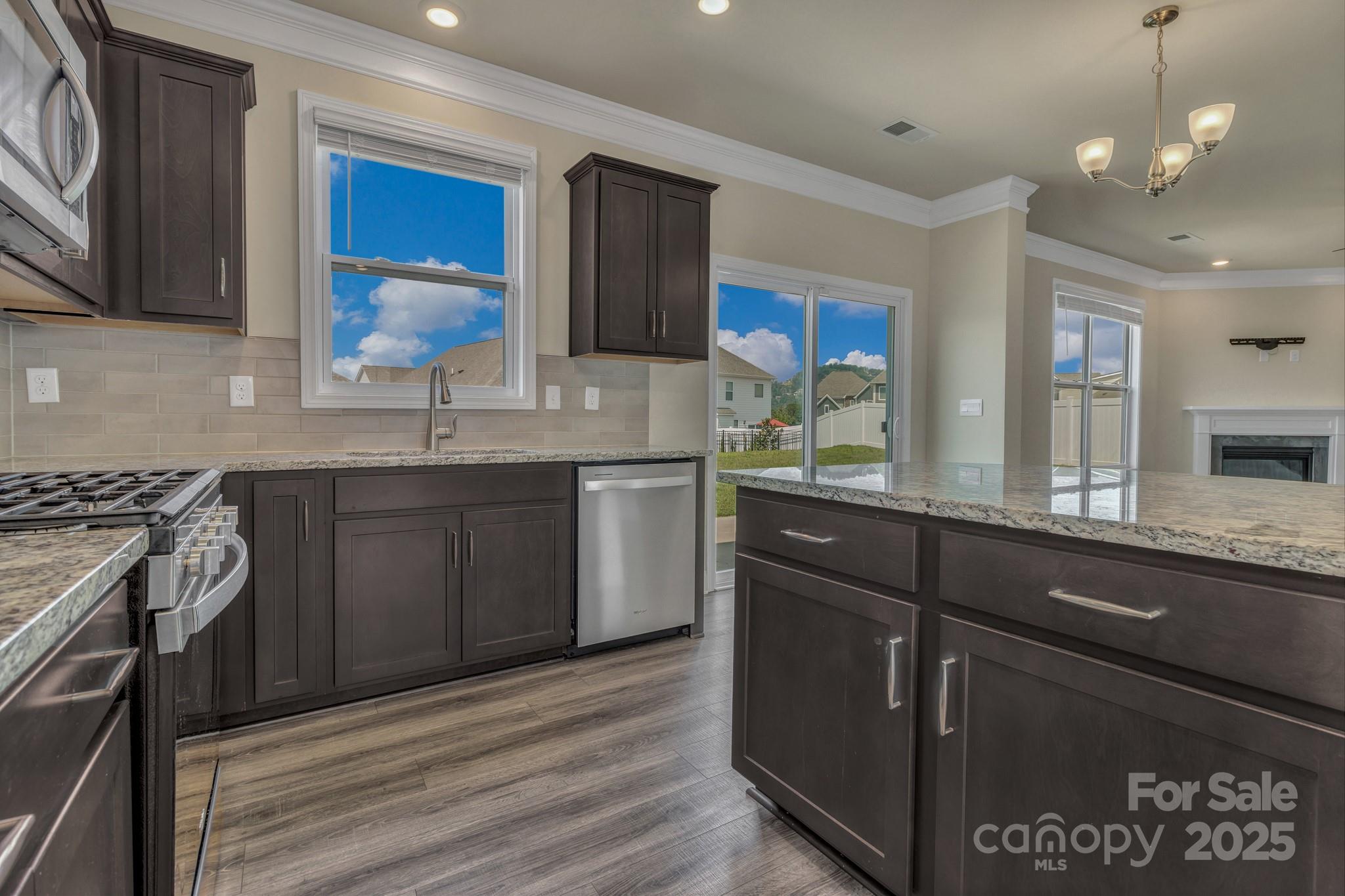 59 Thornberry Road Hendersonville, NC 28792 - Photo 18 of 48 a kitchen with a sink stove and cabinets