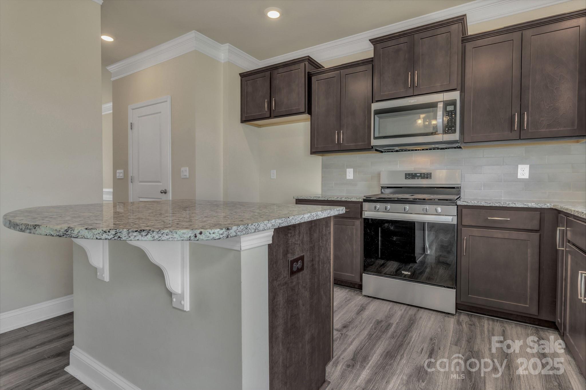 59 Thornberry Road Hendersonville, NC 28792 - Photo 20 of 48 a kitchen with stainless steel appliances granite countertop a stove top oven microwave and refrigerator