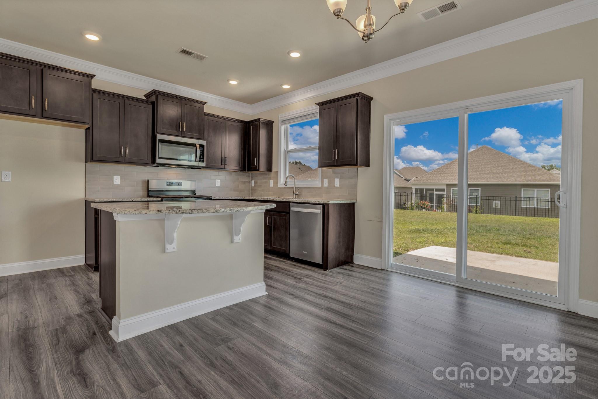 59 Thornberry Road Hendersonville, NC 28792 - Photo 22 of 48 a kitchen with stainless steel appliances granite countertop a stove top oven a sink and a refrigerator