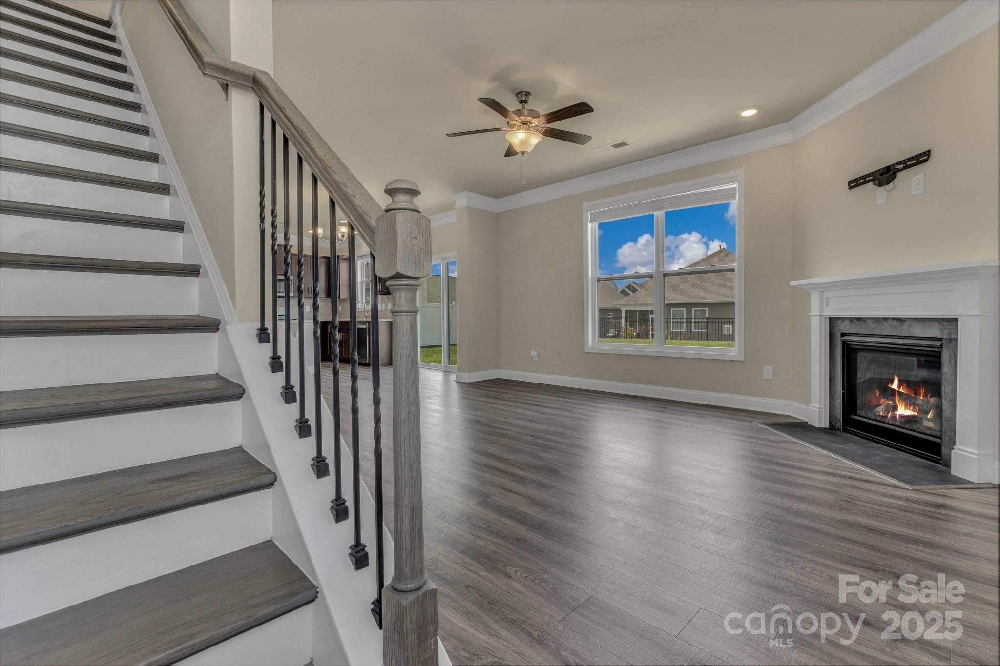 59 Thornberry Road Hendersonville, NC 28792 - Photo 25 of 48 a view of an empty room with wooden floor fireplace and a window