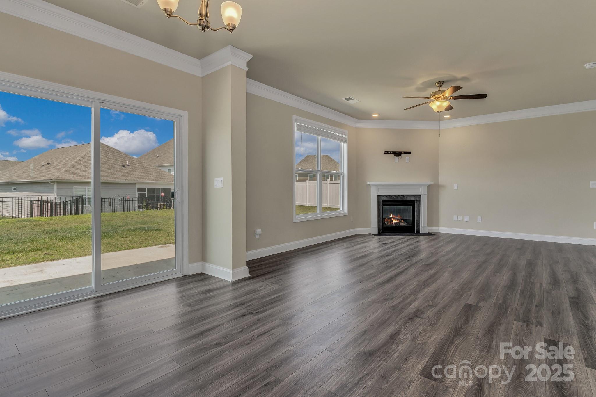59 Thornberry Road Hendersonville, NC 28792 - Photo 9 of 48 an empty room with wooden floor fan and windows
