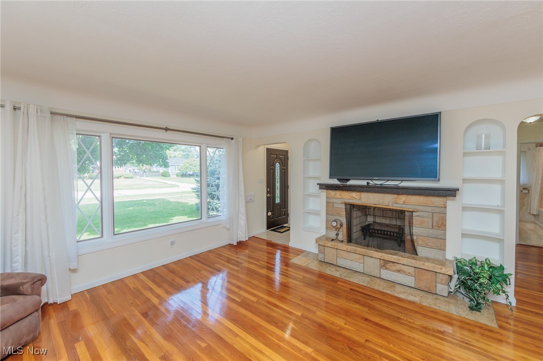 5445 Hauserman Road Cleveland, OH 44130 - Photo 5 of 45 Living room with a fireplace, hardwood / wood-style flooring, and built in shelves
