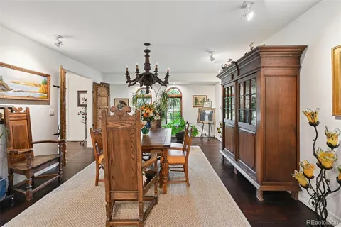 a large bedroom with bed and mirror