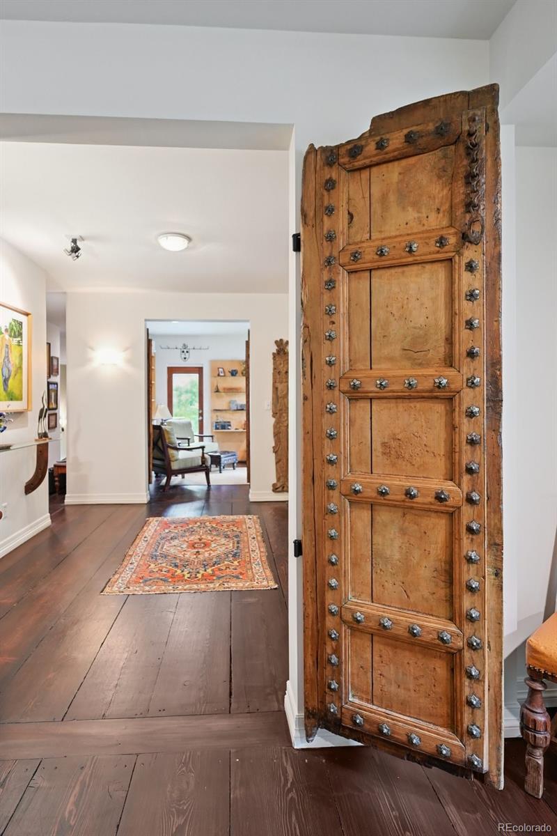 3391 Oak Street Wheat Ridge, CO 80033 - Photo 14 of 50 a large bedroom with bed and mirror