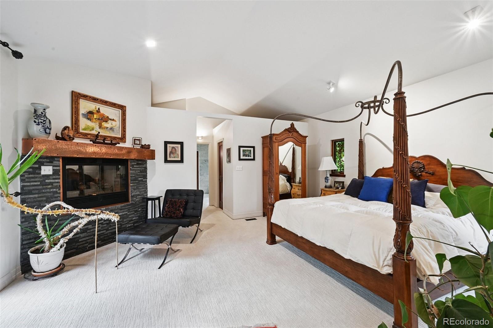 3391 Oak Street Wheat Ridge, CO 80033 - Photo 20 of 50 a bedroom with furniture and a fireplace