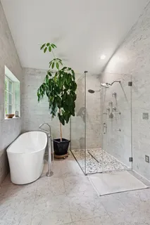 a bathroom with a granite countertop sink and a window
