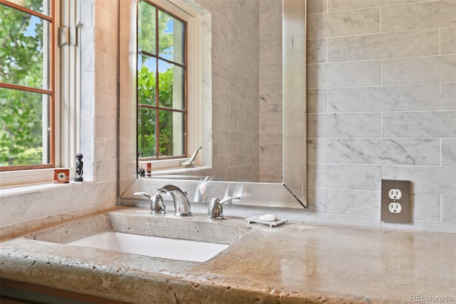 3391 Oak Street Wheat Ridge, CO 80033 - Photo 24 of 50 a bathroom with a granite countertop sink and a window