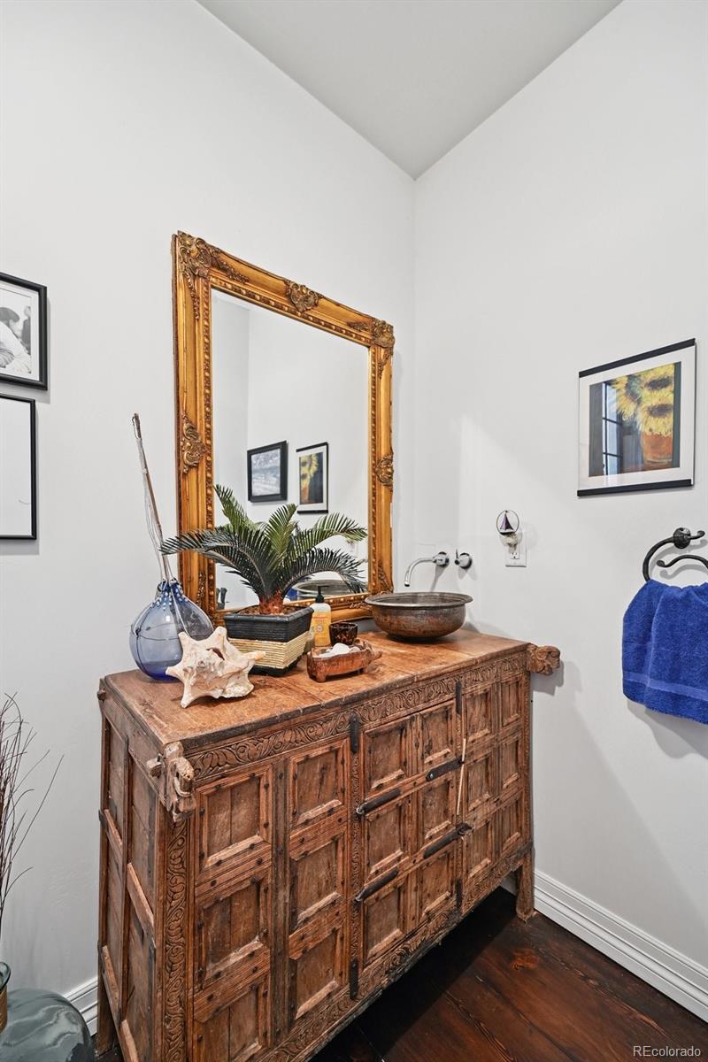 3391 Oak Street Wheat Ridge, CO 80033 - Photo 34 of 50 a room with furniture a mirror and wooden floor
