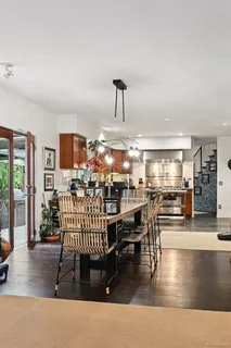 a living room with furniture and floor to ceiling windows