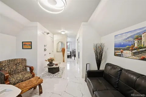 a living room with furniture and floor to ceiling windows